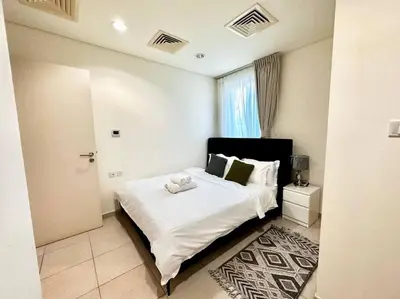 a bedroom with a large white bed and a window at Golf Facing 5Bedroom Villa in Novelia Village in Dubai