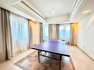 a ping pong table in a room with windows at Golf Facing 5Bedroom Villa in Novelia Village in Dubai