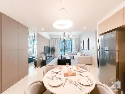 a kitchen and living room with a table and chairs at Luxurious stay Dubai Creek Balcony & View in Dubai