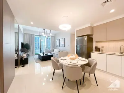 a kitchen and living room with a table and chairs at Luxurious stay Dubai Creek Balcony & View in Dubai