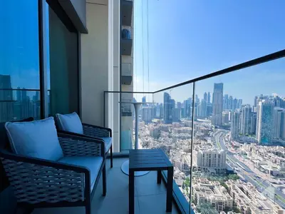 a balcony with chairs and a view of a city at Luxury Burj Royale Burj Khalifa & Fountain view in Dubai
