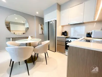 a kitchen with a table and chairs in a kitchen at Luxury Burj Royale Burj Khalifa & Fountain view in Dubai