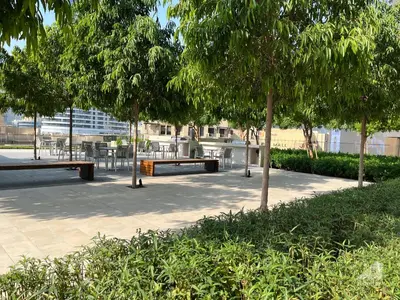 a park with benches and tables and trees at Luxury Burj Royale Burj Khalifa & Fountain view in Dubai