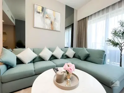 a living room with a blue couch and a table at Luxury Burj Royale Burj Khalifa & Fountain view in Dubai