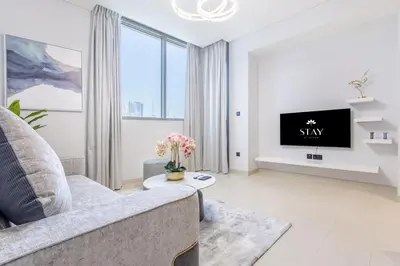 a living room with a couch and a tv at STAY BY LATINEM Luxury 2BR Holiday Home CV A814 near Burj Khalifa in Dubai