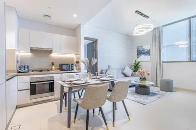 a kitchen and living room with a table and chairs at STAY BY LATINEM Luxury 2BR Holiday Home CV A814 near Burj Khalifa in Dubai
