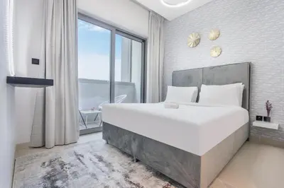 a bedroom with a large white bed and a large window at STAY BY LATINEM Luxury 2BR Holiday Home CV A814 near Burj Khalifa in Dubai