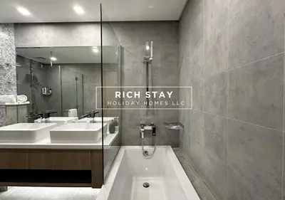 a bathroom with two sinks and a tub and a mirror at Harmonious 3BR in Stella Maris, Sea View, Marina in Dubai