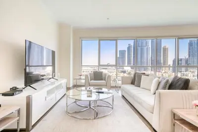 a living room with a couch and a tv at Burj Residence 1, Downtown Dubai - Mint Stay in Dubai