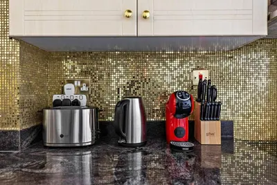 a kitchen counter with two coffee makers on it at StoneTree - Elegant Studio in Goldcrest View in Dubai