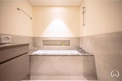 a bathroom with a bath tub and a sink at Oraya - Modern Apt 5 min walk to Dubai Mall & Burj Views in Dubai