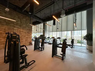 a gym with several treadmills and machines in a room at Oraya - Modern Apt 5 min walk to Dubai Mall & Burj Views in Dubai
