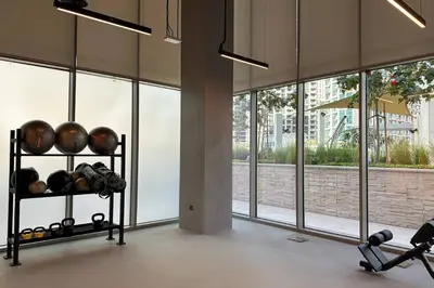 a gym with large windows and a rack of balls at Oraya - Modern Apt 5 min walk to Dubai Mall & Burj Views in Dubai