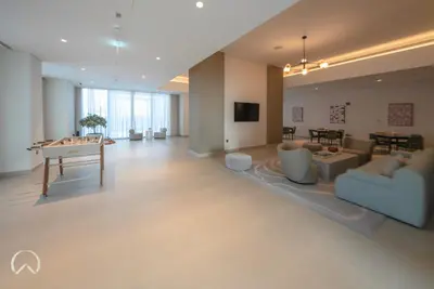 a living room with a couch and a table at Oraya - Modern Apt 5 min walk to Dubai Mall & Burj Views in Dubai
