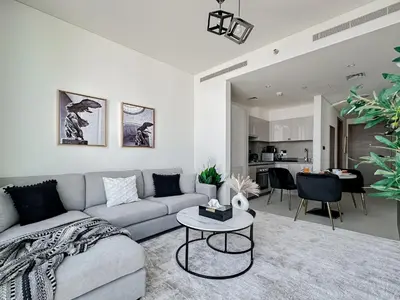 a living room with a couch and a table at Trophy - Cozy Elegant Suites in Dubai