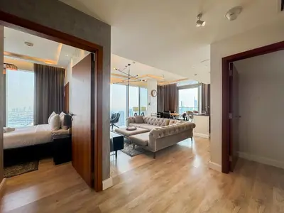 a large living room with a couch and a bed at High floor Luxury 2BR - Dubai Marina Gate in Dubai