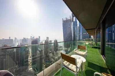 a balcony with chairs and a view of the city at High floor Luxury 2BR - Dubai Marina Gate in Dubai