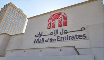 a mall of the emirates sign on a building at Partition Room With Window Near MOE Metro in Dubai