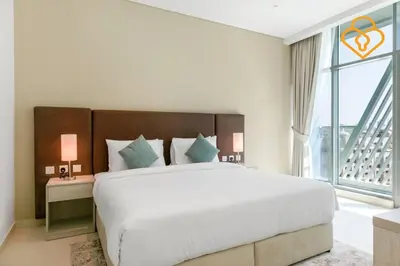a bedroom with a large bed and a large window at Keysplease Beautiful 1 B/R Palm Jumeirah Beach Access in Dubai