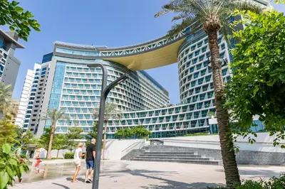 people walking in front of a large building at Keysplease Beautiful 1 B/R Palm Jumeirah Beach Access in Dubai