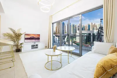 a living room with a couch and a large window at Luxury 1 Bedroom Full Marina View, Sleeps 6, 1 Min to Metro in Dubai