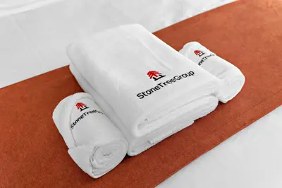 a group of white towels sitting on a table at StoneTree - Fully Furnished 1BR in Dubai Marina in Dubai