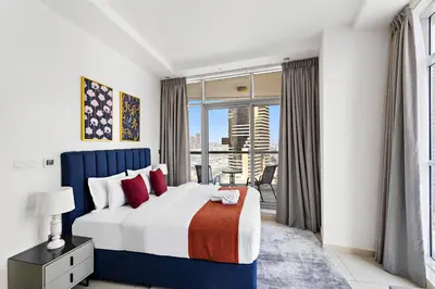 a bedroom with a bed and a large window at StoneTree - Fully Furnished 1BR in Dubai Marina in Dubai