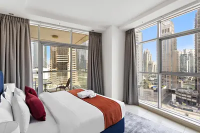 a bedroom with a bed and a large window at StoneTree - Fully Furnished 1BR in Dubai Marina in Dubai