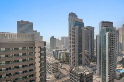 an aerial view of a city with tall buildings at StoneTree - Furnished 1BR with Spacious Balcony in Dubai