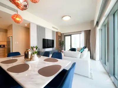 a living room with a large table and a couch at Luxurious Apt with breathtaking view in Downtown in Dubai