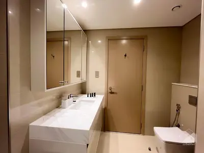 a bathroom with a large white sink and a mirror at Luxurious Apt with breathtaking view in Downtown in Dubai