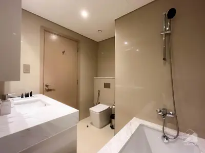 a bathroom with a shower and a sink and a toilet at Luxurious Apt with breathtaking view in Downtown in Dubai