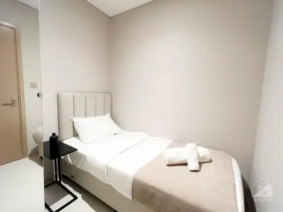 a white bedroom with a bed and a mirror at Luxurious Apt with breathtaking view in Downtown in Dubai