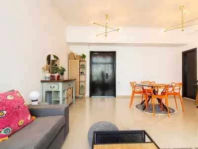 a living room with a couch and a table at Cozy 1 BR in Dubai Marina in Dubai