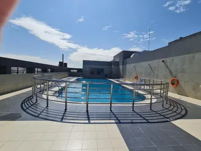 a swimming pool on the roof of a building at Studio in Dubai