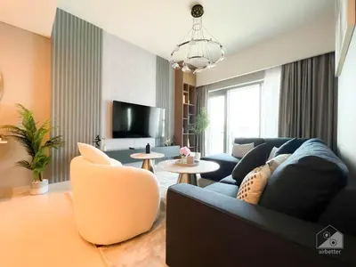 a living room with a blue couch and a chair at Majestic 2Bedroom in Burj Royale Downtown in Dubai