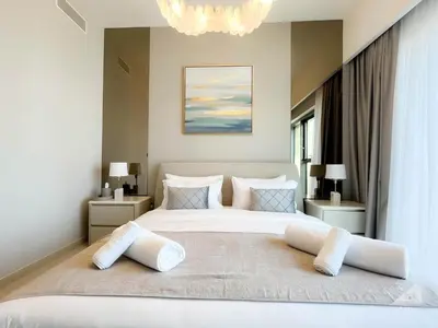 a bedroom with a large white bed with pillows at Majestic 2Bedroom in Burj Royale Downtown in Dubai