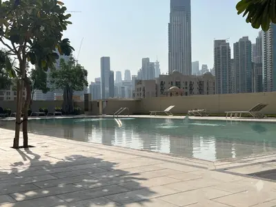 a swimming pool with a city skyline in the background at Majestic 2Bedroom in Burj Royale Downtown in Dubai
