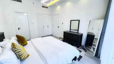 a white bedroom with a bed and a mirror at Jumeriah Lake Tower(JLT)- (MAG214)(2) in Dubai