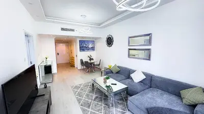 a living room with a blue couch and a table at Jumeriah Lake Tower(JLT)- (MAG214)(2) in Dubai