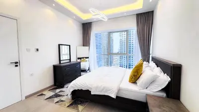 a bedroom with a bed and a large window at Jumeriah Lake Tower(JLT)- (MAG214)(2) in Dubai