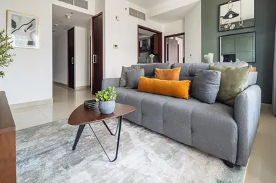 a living room with a gray couch and a table at Frank Porter - 29 Boulevard in Dubai