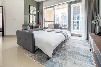 a large bed in a room with a large window at Frank Porter - 29 Boulevard in Dubai