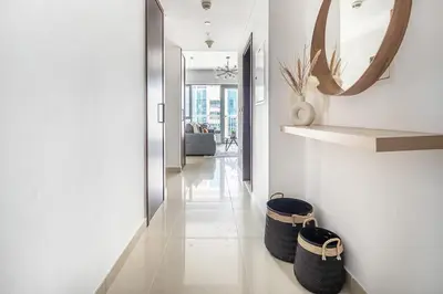 a hallway with two baskets on the floor and a mirror at Frank Porter - 29 Boulevard in Dubai