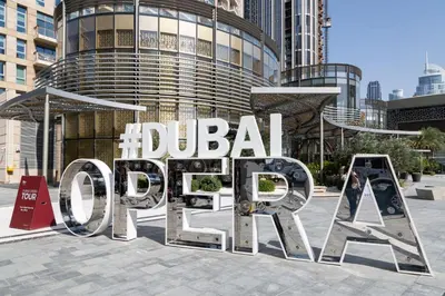 a large metal sign in front of a building at Frank Porter - 29 Boulevard in Dubai