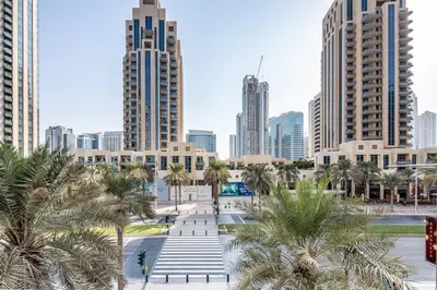 a city skyline with palm trees and buildings at Frank Porter - 29 Boulevard in Dubai