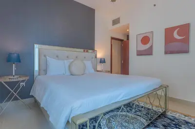 a bedroom with a large white bed in a room at Bella Vista - 29 Boulevard Downtown - 2BR - Partial Fountain View in Dubai