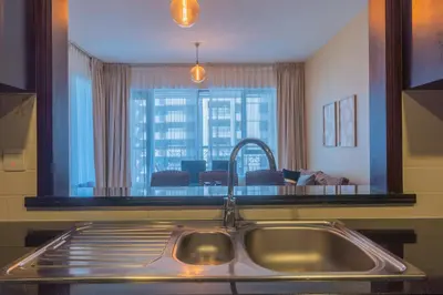 a kitchen sink with a large mirror above it at Bella Vista - 29 Boulevard Downtown - 2BR - Partial Fountain View in Dubai