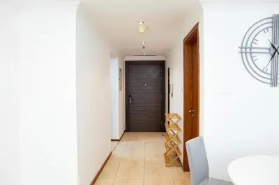 a hallway with a door and a tile floor at Jumeriah Lake Tower (JLT)-(MAG214)(1) in Dubai