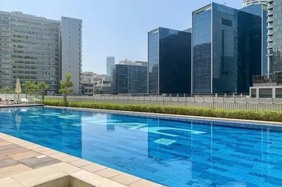 a large blue swimming pool on top of a building at Frank Porter - Reva Residences in Dubai